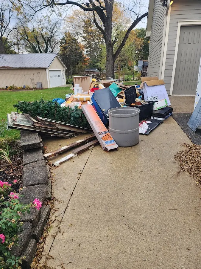 Dumpster being loaded with debris for Estate Cleanout Dumpster Rental in Melody Hill